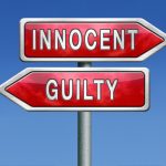 sign showing innocent one way and guilty another