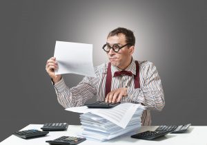 IRS auditor closely examines records while doing attorney audit
