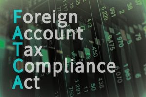 The words "Foreign Account Tax Compliance Act" laid over a computer screen showing a spreadsheet